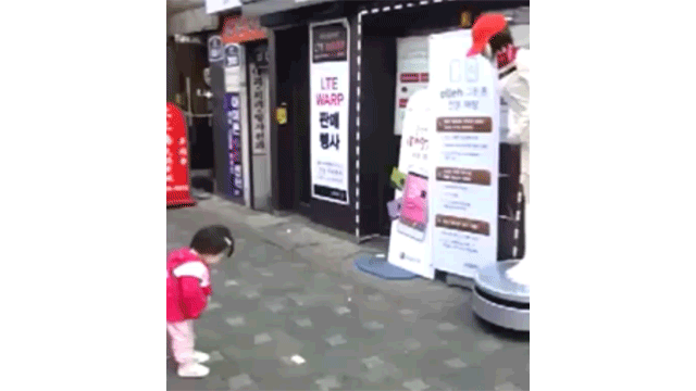 Adorable Little Girl Practices Bowing With A Korean Robot