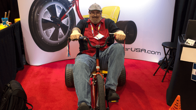 A Very Happy Man On An Adult-Sized Big Wheel