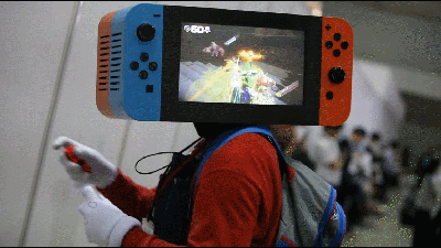 Cosplayer Has A Nintendo Switch For A Head, Plays Arms On It