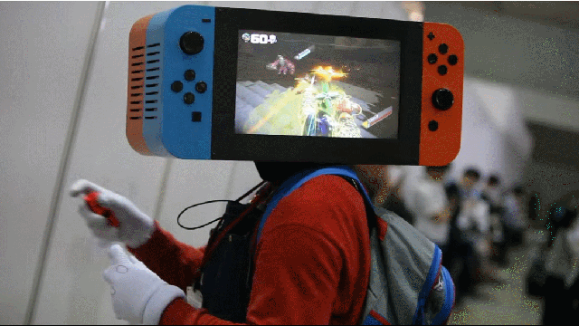 Cosplayer Has A Nintendo Switch For A Head, Plays Arms On It