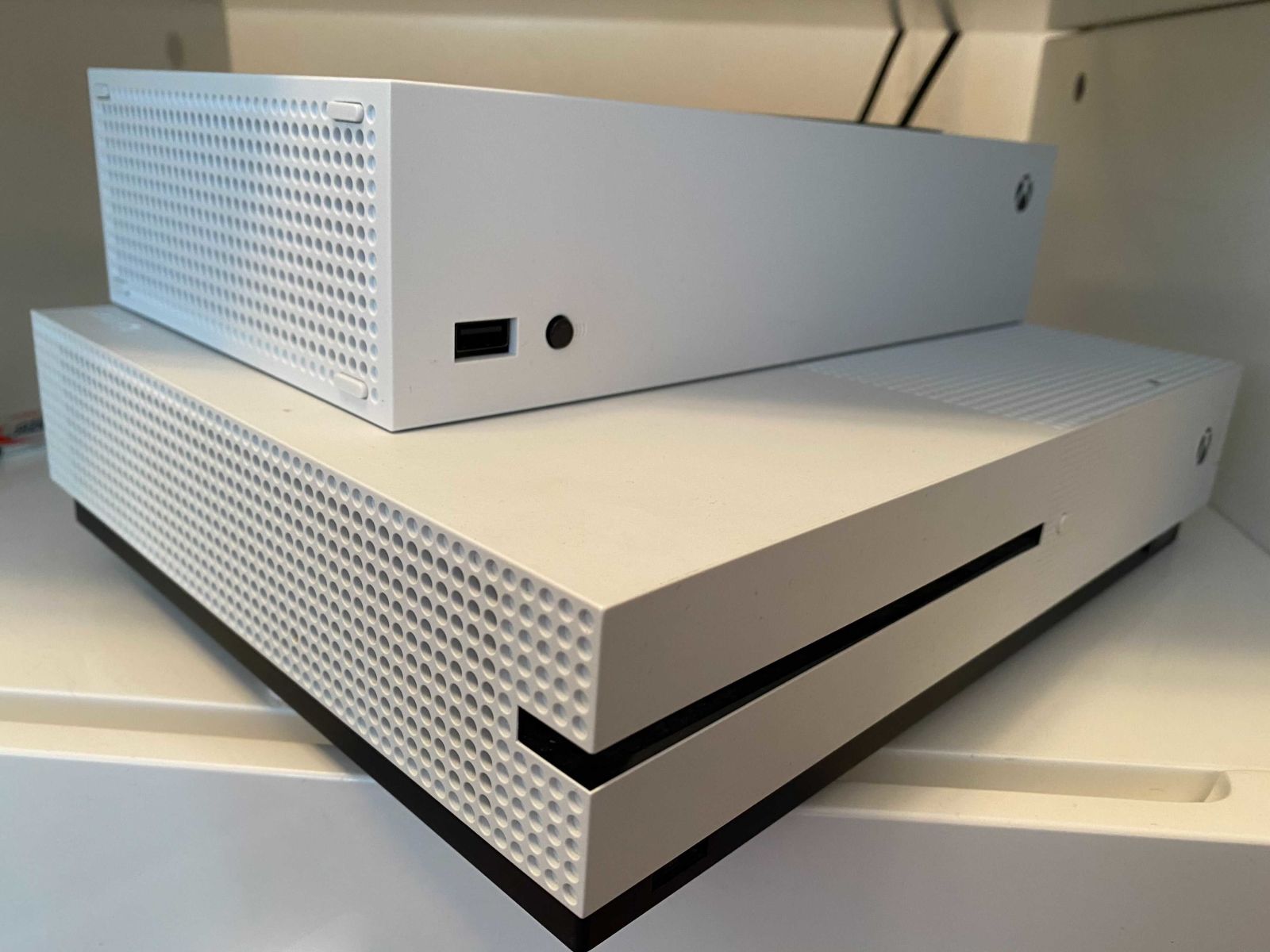 The Xbox Series X sitting atop the much larger Xbox One S.  (Photo: Kotaku)