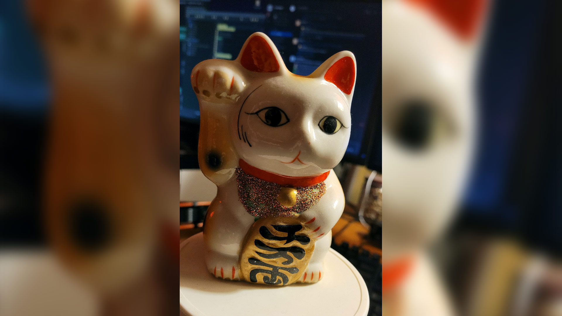 I can't find the cursed copy of Borderlands but this neko lives below my TV as a little memorial to my friend. (Photo: Alexandra Hall / Kotaku)