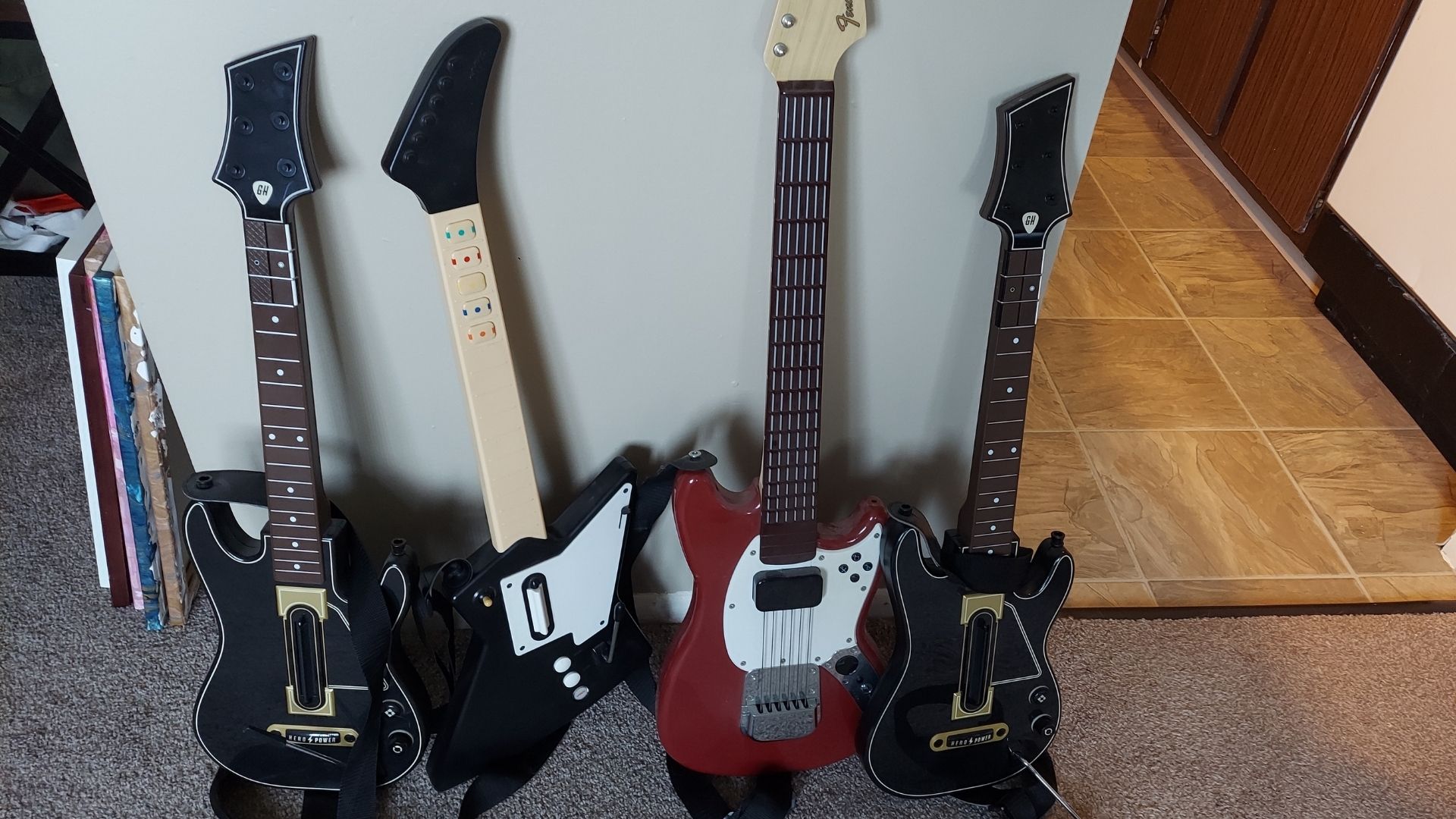 My partner has a lot of guitars, only the one second from the left works.  (Photo: Kotaku)