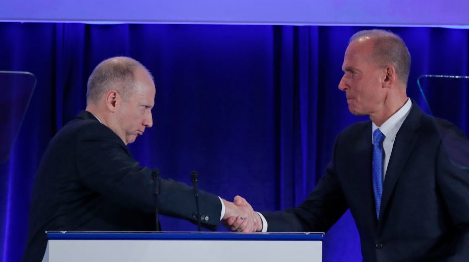 Dixton (left) shakes hands with Boeing chief executive Dennis Muilenburg. (Photo: Pool, Getty Images)