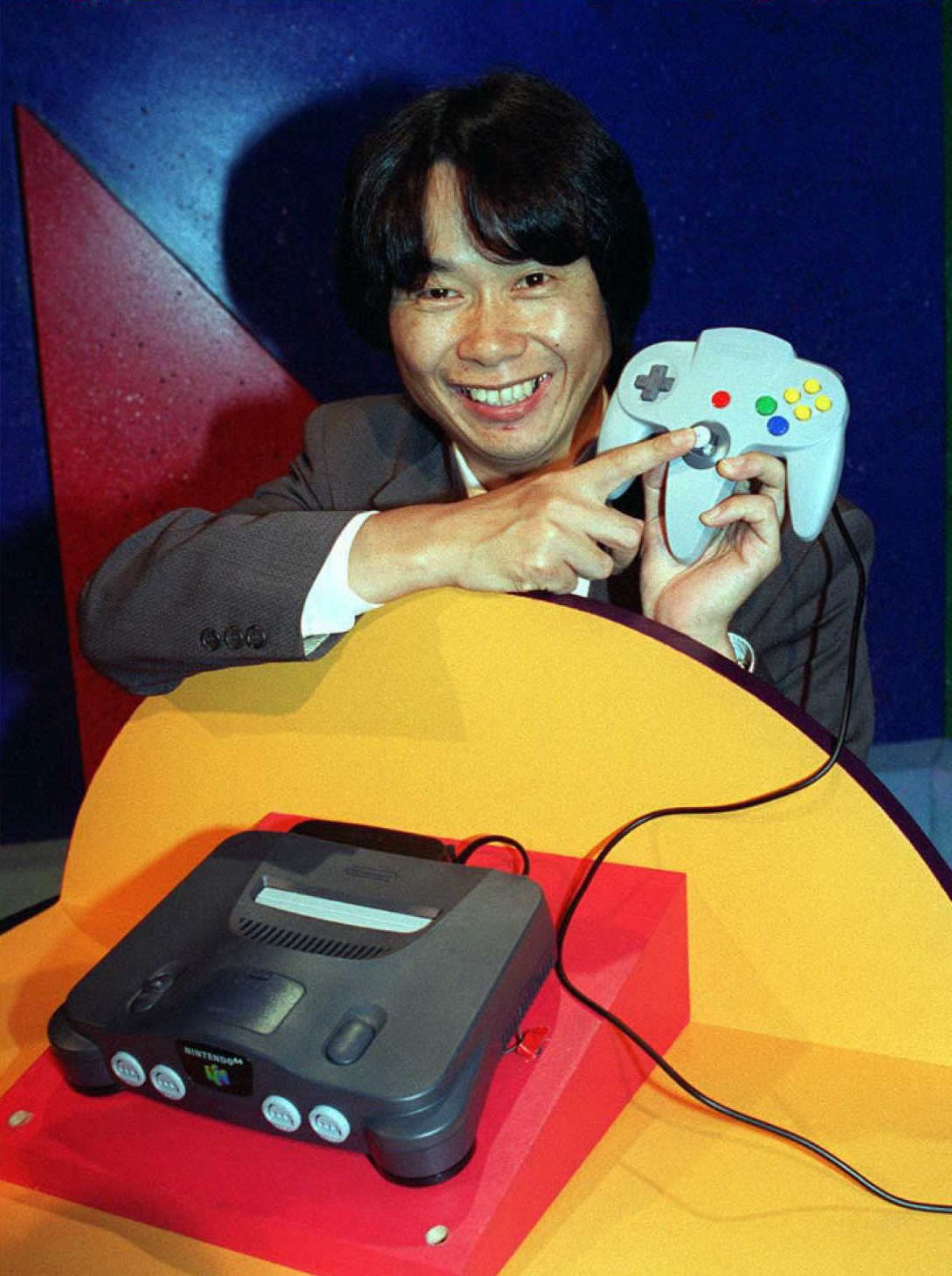 Shigeru Miyamoto shows off the Nintendo 64 and its controller (Photo: JOHN T. BARR/AFP via Getty Images, Getty Images)
