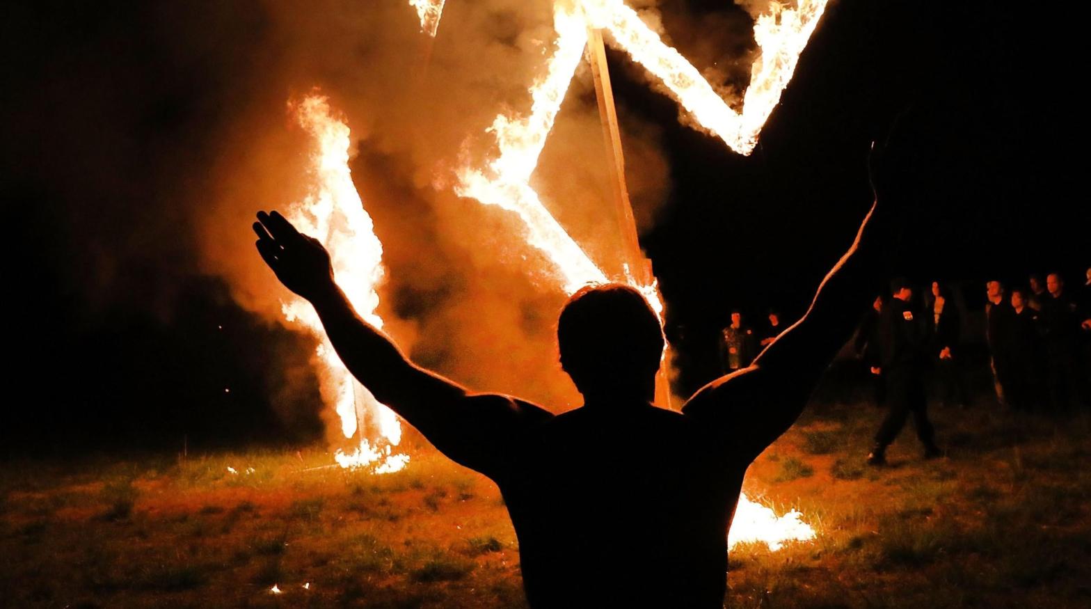 Members of the National Socialist Movement, one of the largest neo-Nazi groups in the US, hold a swastika burning after a rally on April 21, 2018 in Draketown, Georgia.  (Photo: Spencer Platt, Getty Images)