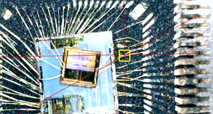 Pictured is inside the MediaTek chip package. The yellow box shows where the two lines intersect. Hackers aimed to drill exactly at this point.  (Screenshot: Modern Vintage Gamer/YouTube)
