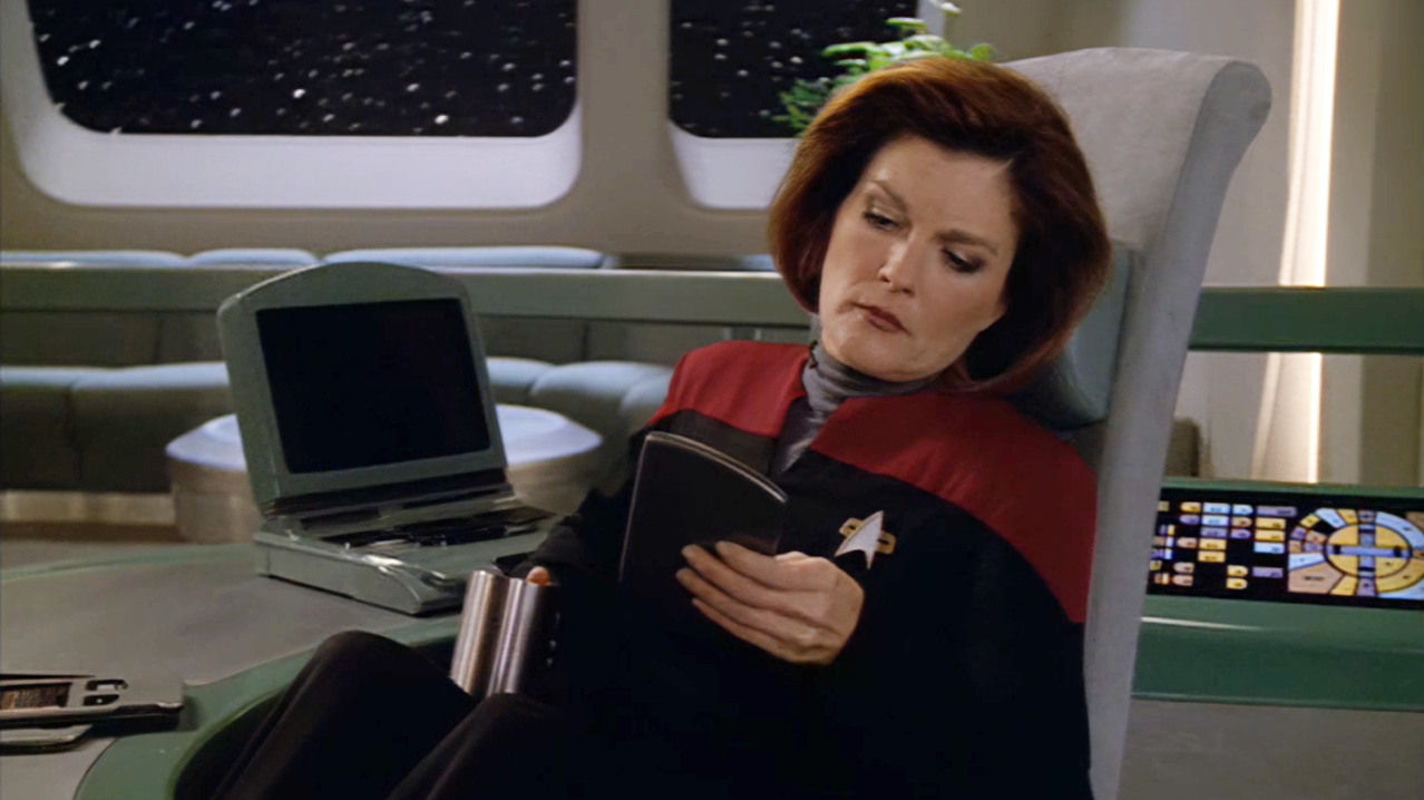 Janeway gets some reading in. (Screenshot: Paramount+)