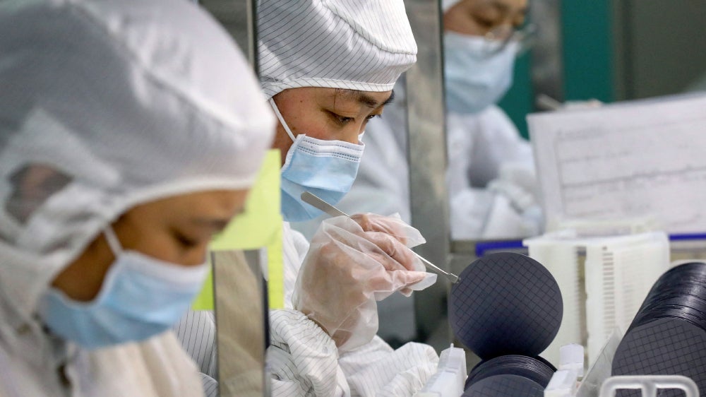 Employees at Jiejie Semiconductor Company in Nantong, China making chips this past March.  (Photo: STR/AFP, Getty Images)