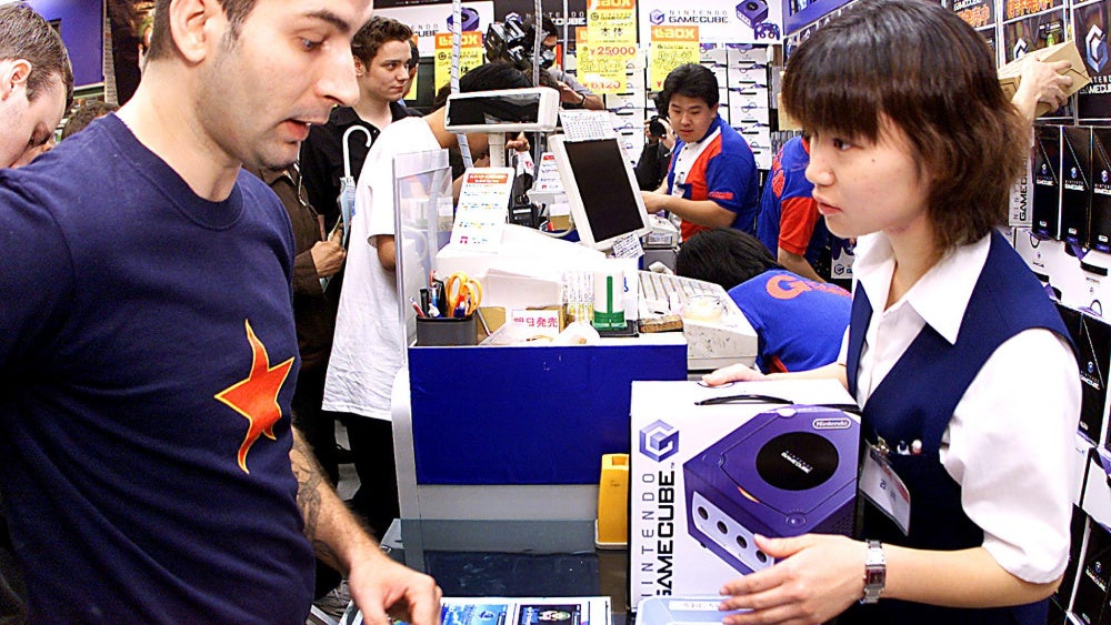 In the above photo from the GameCube's Japan launch, a customer buys the then new Nintendo console at an Akihabara retailer.  (Photo: YOSHIKAZU TSUNO/AFP, Getty Images)