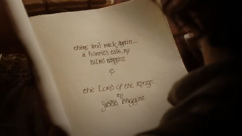 Frodo closes the book, literally, on his and Bilbo's retelling of the final years of the Third Age. (Screenshot: Warner Bros.)