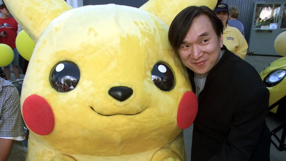 Tsunekazu Ishihara poses with Pikachu in this file photo.  (Photo: HECTOR MATA/AFP, Getty Images)