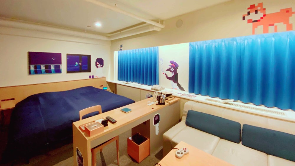 There are even controllers on the table so people can play.  (Image: Hotel Anteroom Kyoto/Hako Life)