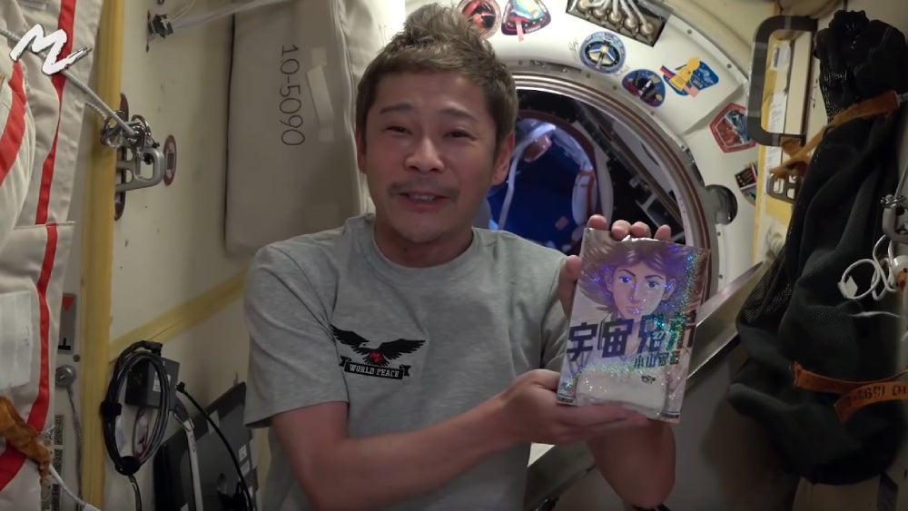 The Space Brothers manga being reviewed in space.  (Screenshot: MZ/YouTube)