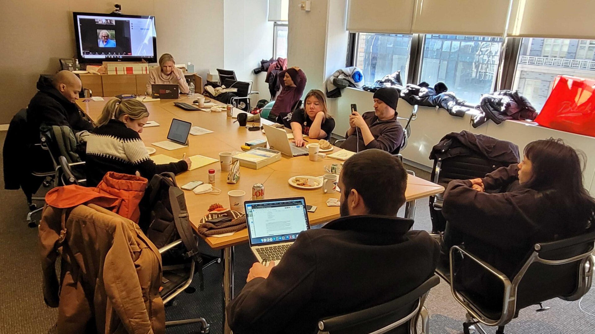 Called away from the rally, the GMG bargaining committee gathered at the offices of the Writers Guild of America, East, alongside teleconferenced colleagues, for a sudden bargaining session that lasted into the next morning. (Photo: Kotaku)