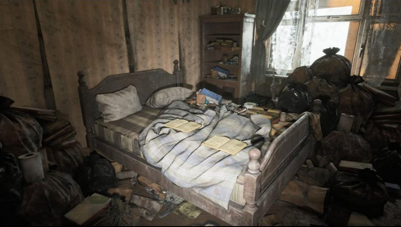 A leaked Silent Hill image from sleuther Dusk Golem showing an unkempt bedroom covered in boxes and books and garbage, again possibly indicating that this spot belongs to some sorta hoarder in the game. (Image: Konami / Dusk Golem / Silent Hill / Kotaku)