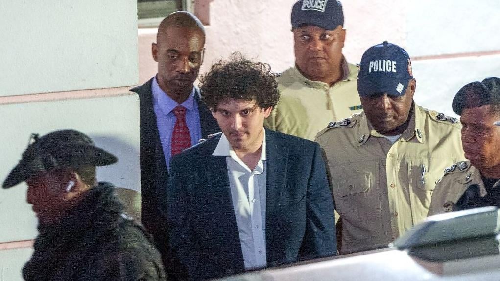FTX founder Sam Bankman-Fried is led away in custody after being arrested in The Bahamas last week (Photo: MARIO DUNCANSON, Getty Images)