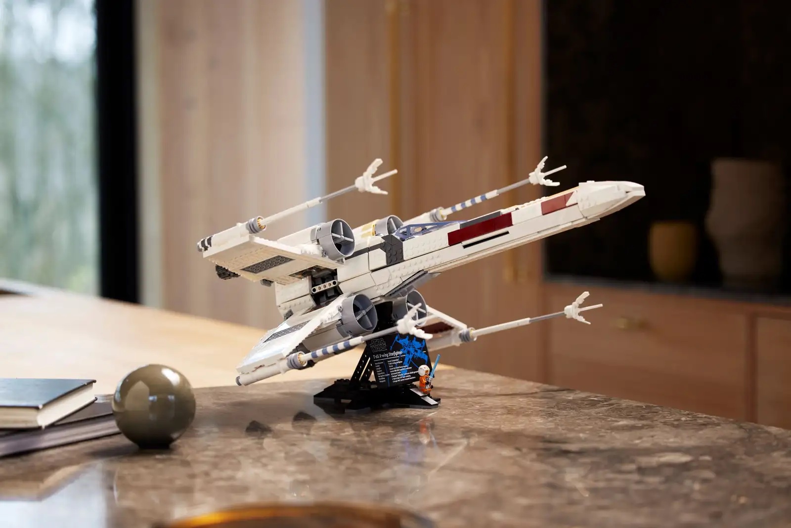 A LEGO X-Wing Starfighter on a kitchen bench